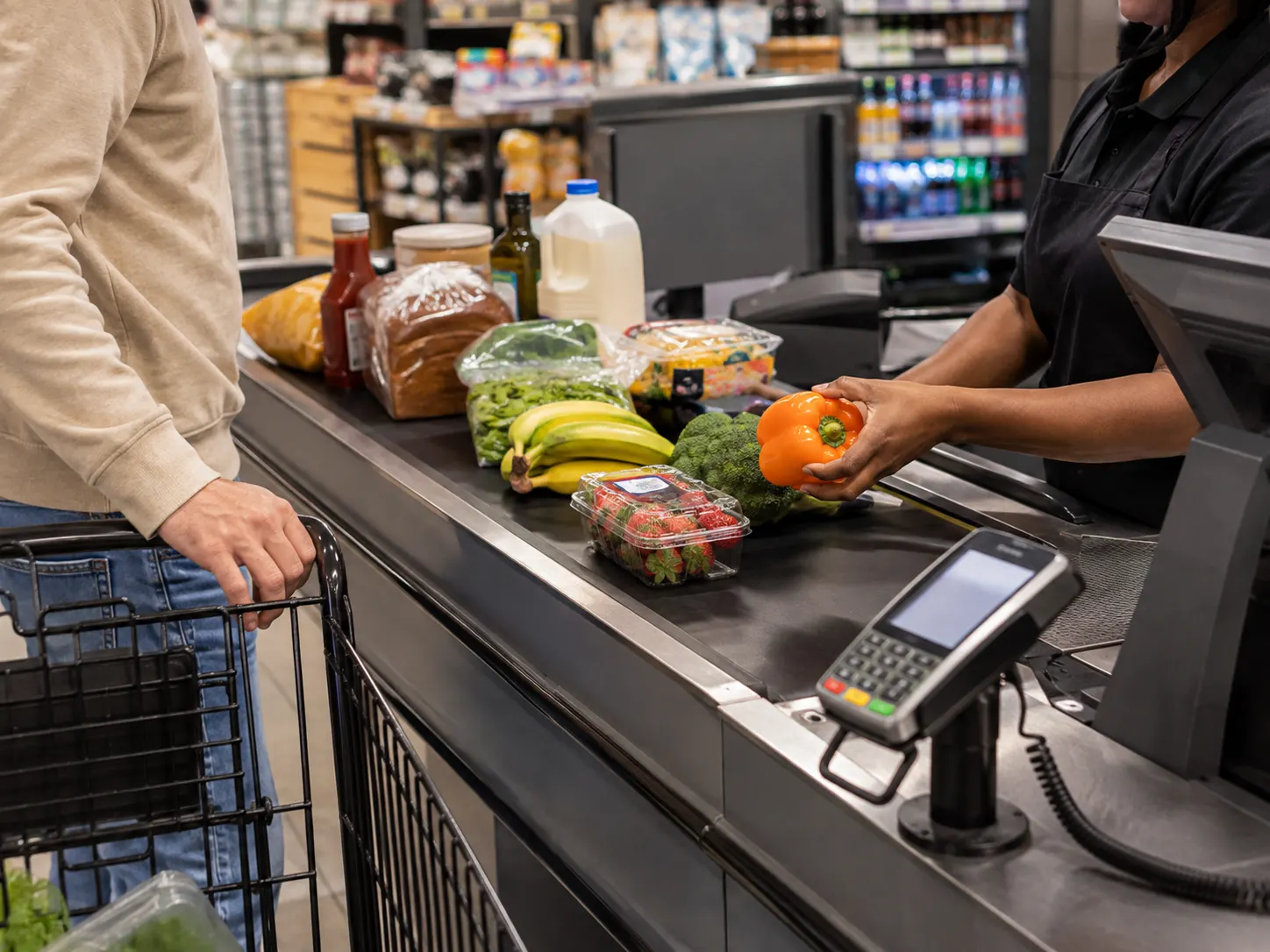 Everyday groceries moving through a supermarket checkout